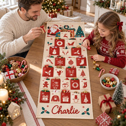 May include: A fabric Christmas advent calendar hanging vertically, featuring twenty-four numbered red pockets with white holiday icons. The calendar displays a Santa illustration at the top and the name Charlie embroidered in red at the bottom.