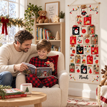 May include: A vertical fabric advent calendar hanging on a wall, featuring twenty-four numbered pockets decorated with festive holiday icons like Santa, trees, and gifts. The bottom of the cream-colored canvas displays the name Noah in black script.