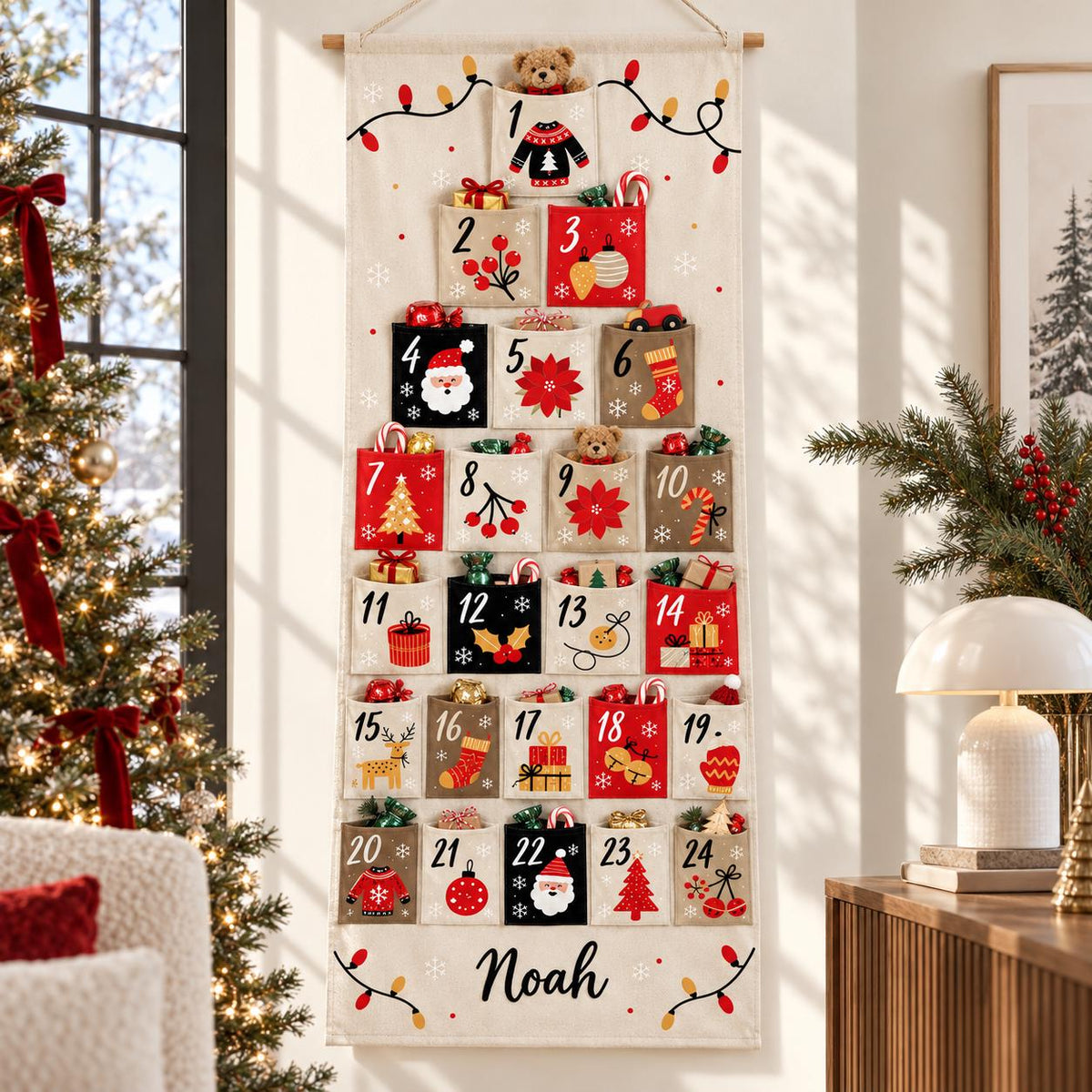 May include: A vertical fabric advent calendar hanging from a wooden rod, featuring twenty-four numbered pockets in red, black, and beige. Each pocket displays festive holiday icons like Santa, trees, and gifts. The name Noah is printed at the bottom.